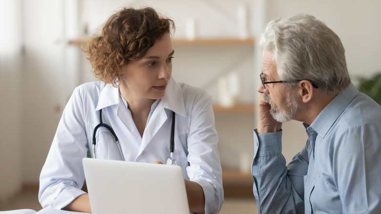 A doctor speaks with a patient