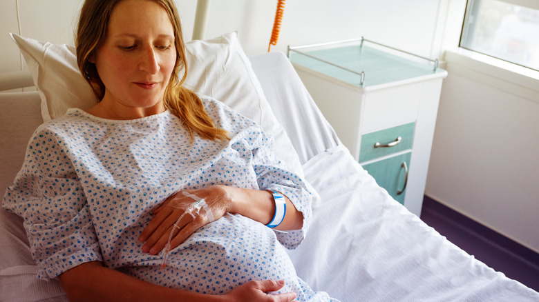 pregnant woman in hospital with IV in hand