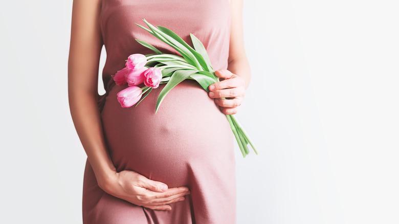 Pregnant woman holding flowers