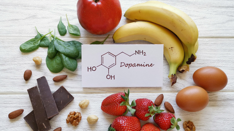 A variety of foods surrounding a sign that says "dopamine"