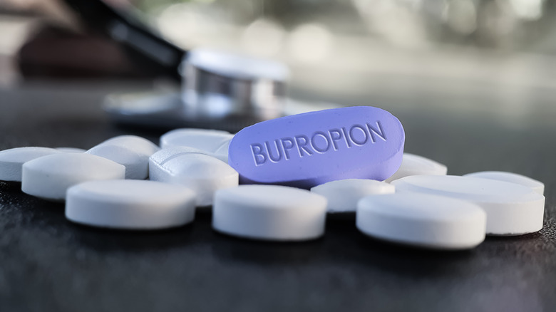 Bupropion pull surrounded by white pills