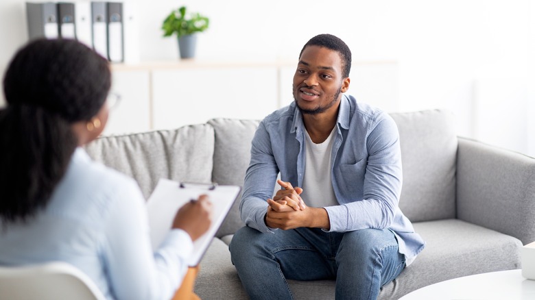 man talking to woman therapist