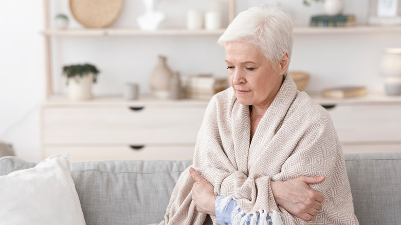 Woman holding a shawl around herself