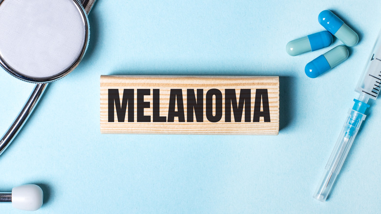 Wooden block reading "melanoma"