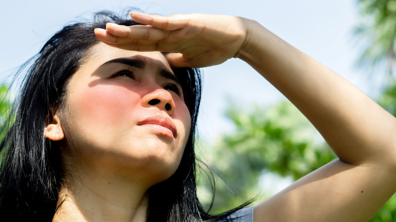 Woman shielding her eyes from the sun