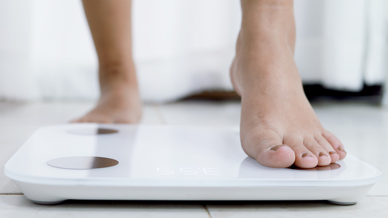 feet standing on electronic scale