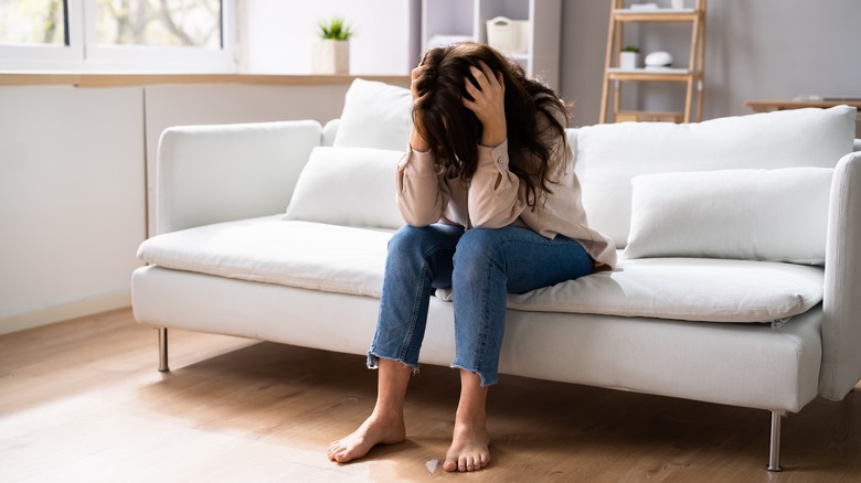 woman sitting with head down