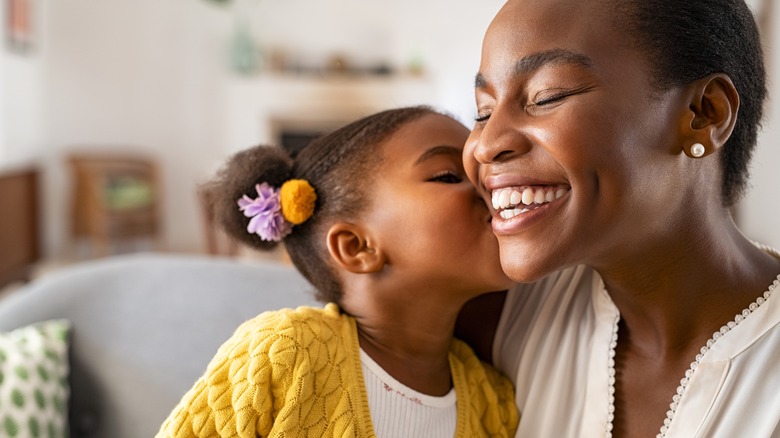 Young child kissing mother's cheek