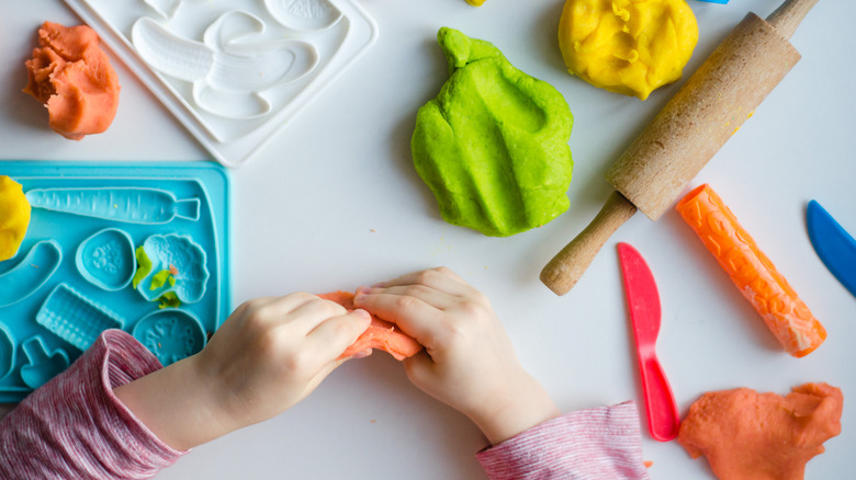 Child's hands playing with Play-Doh