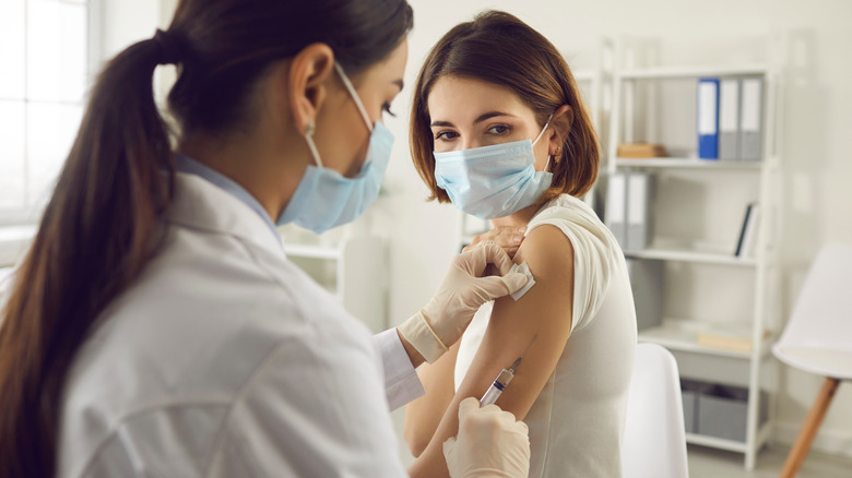Doctor giving a woman a vaccine shot