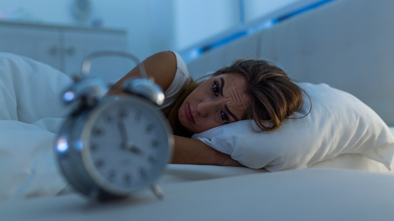 woman lying in bed with insomnia