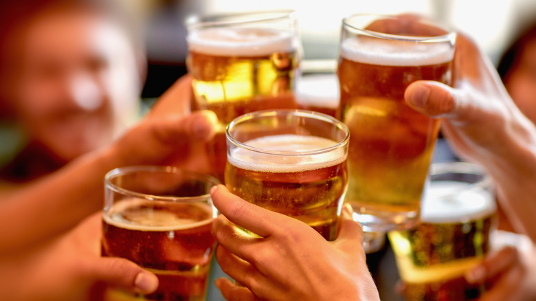 Friends clinking beer glasses