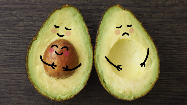 Avocados as "parents," one with a pit, happy to be "pregnant" one without a pit, sad to not be "pregnant"