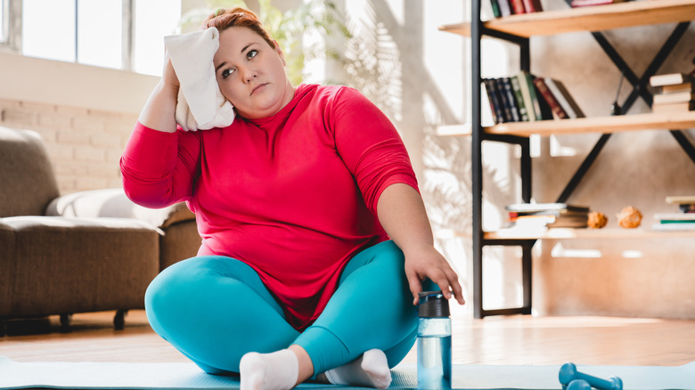 woman wiping sweat off face