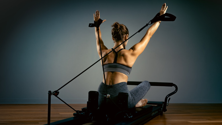 woman using reformer