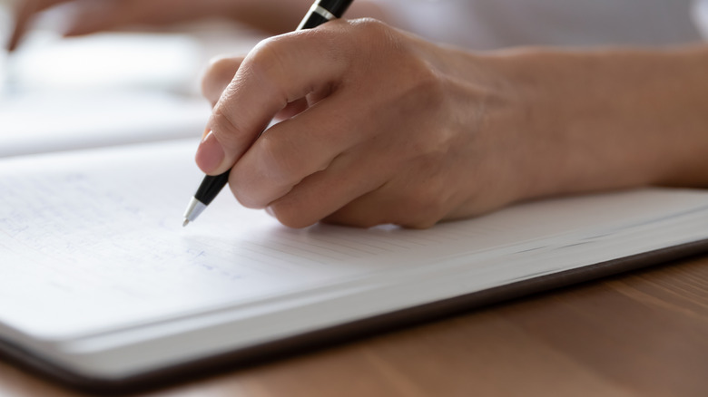 woman writing in a journal