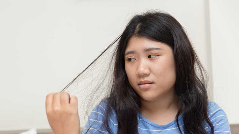 woman pulling out her hair