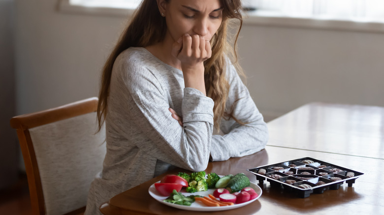 woman staring at food dieting