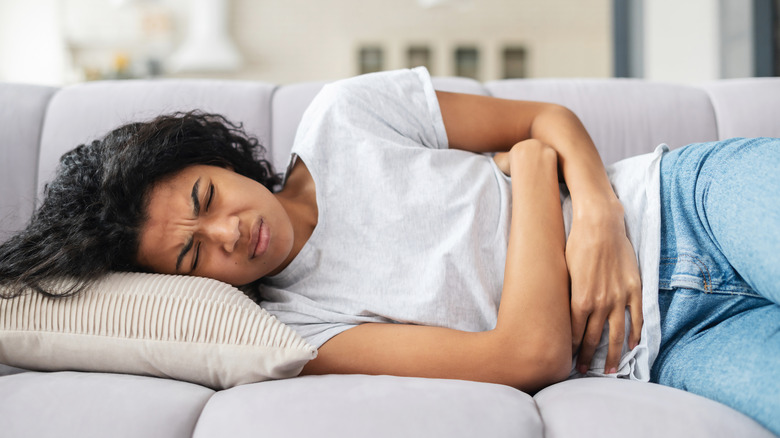 Woman lying down in severe pain