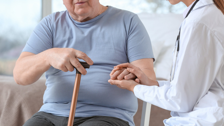 Doctor examining patient's hand