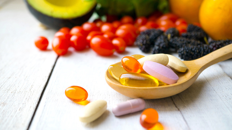 Pills with fruits in the background