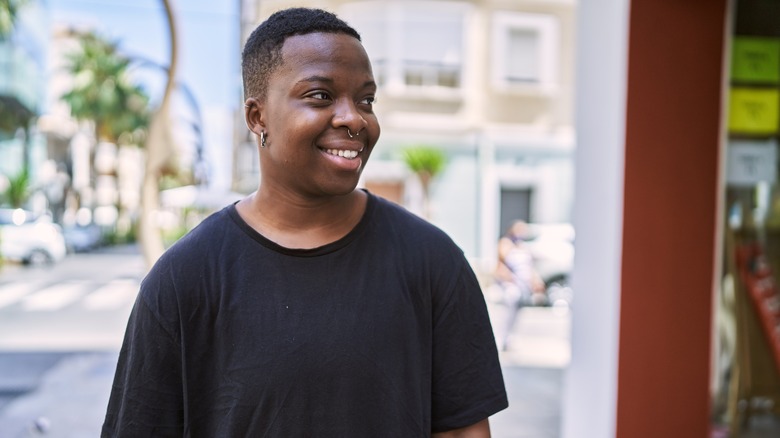 Young Black trans man walking down the street