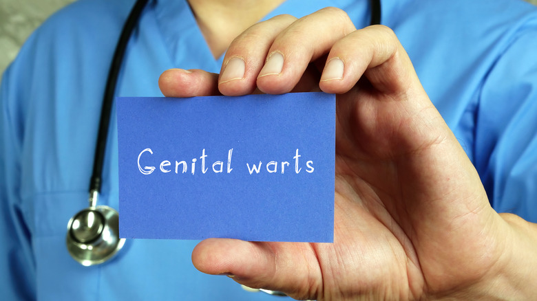 Doctor with Genital warts sign