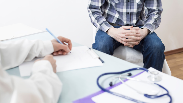 Man speaking with doctor