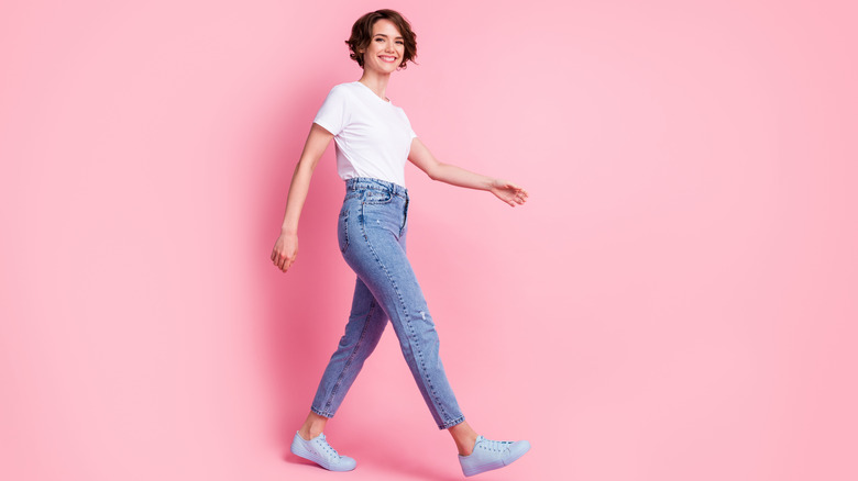 woman walking in t-shirt and jeans