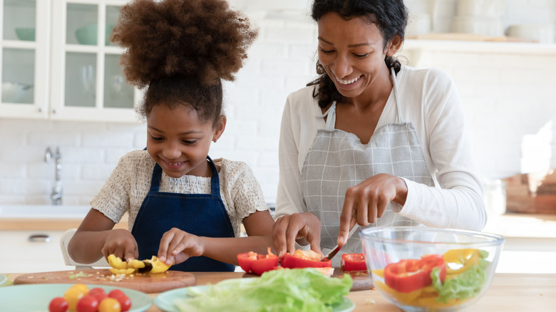 mother and daughter making healthy salad