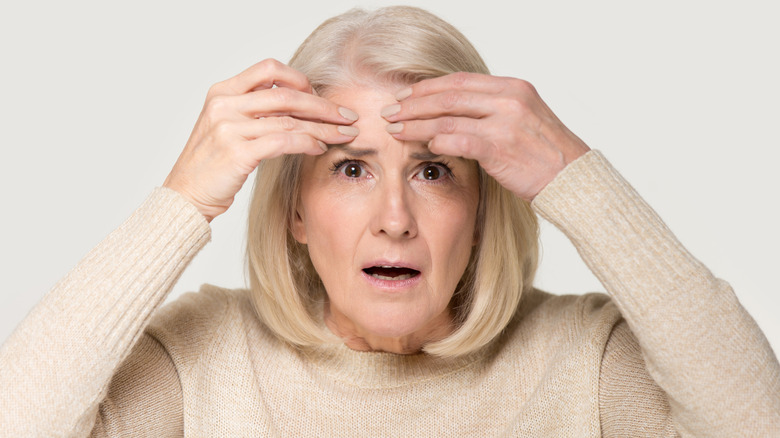 surprised older woman staring straight ahead