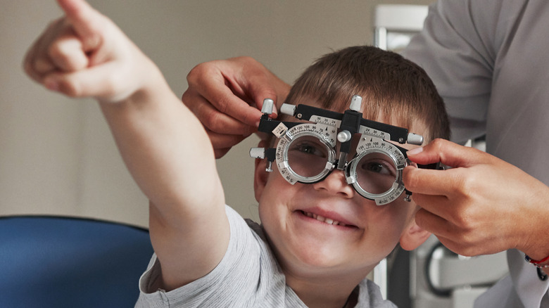 Happy boy getting eye test