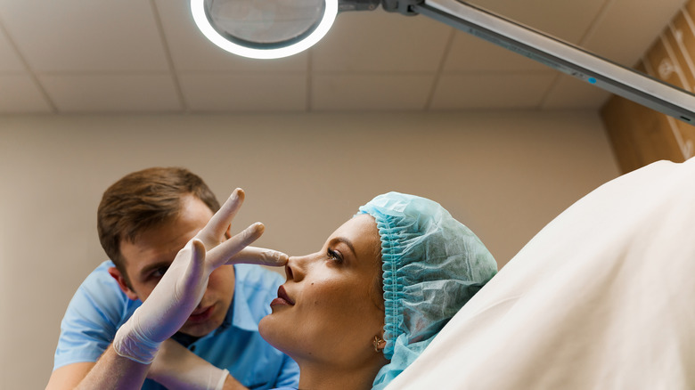 doctor examining patient's face