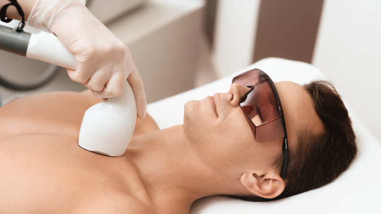 man getting laser hair removal on chest