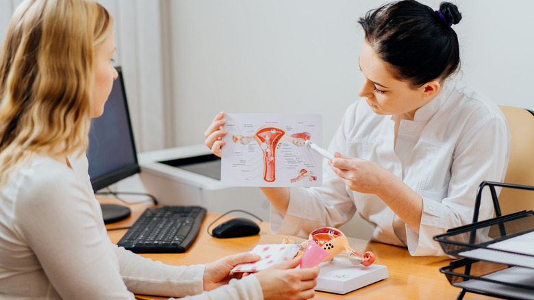 doctor instructing woman about menstruation