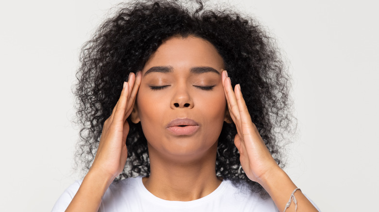 woman massaging her temples