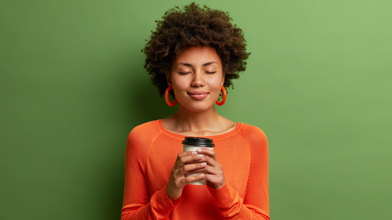 woman enjoying a takeaway coffee