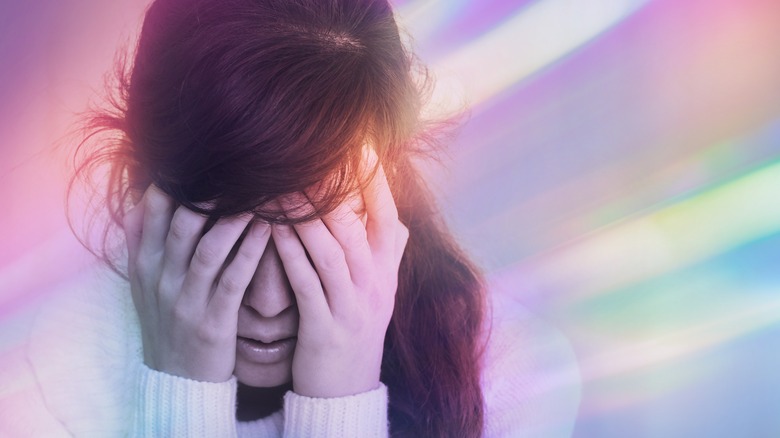 woman experiencing a migraine aura