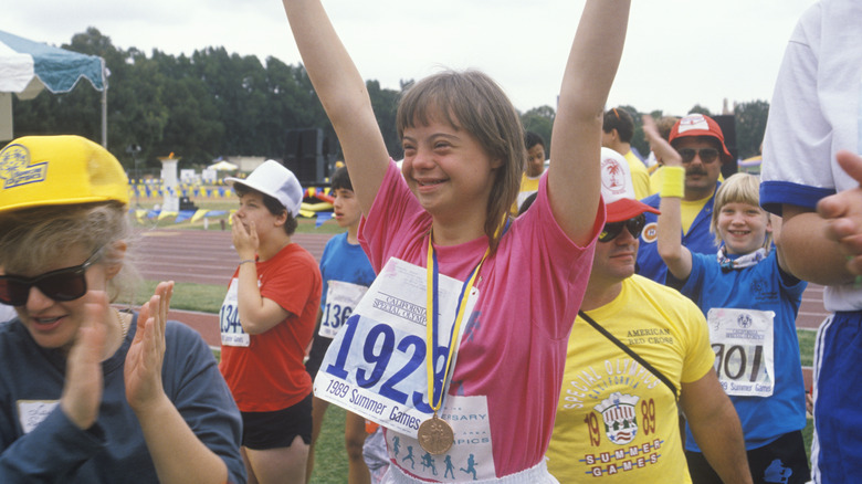 Girl wearing Special Olympics gold medal