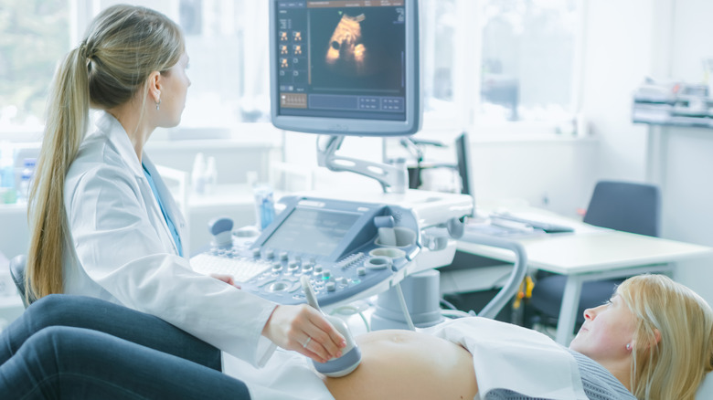 Woman getting ultrasound from female clinician