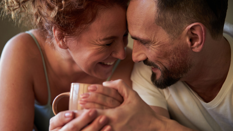 couple smiling and holding hands 