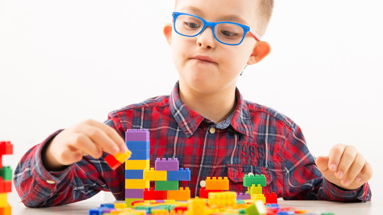 Little boy playing with LEGO bricks