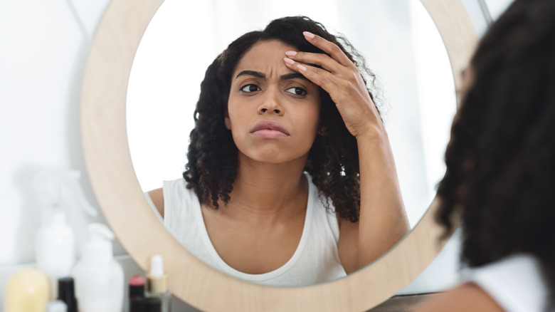 Woman looking at herself in the mirror