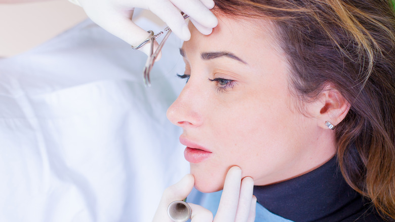 Woman receiving cosmetic treatment