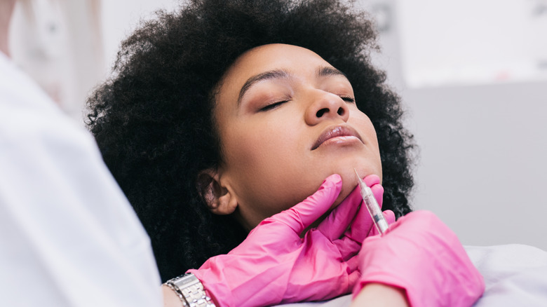 Woman getting an injection in her chin