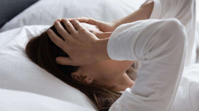 Woman in bed with headache