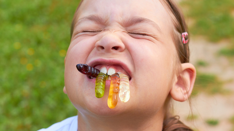 Child eating gummy worms
