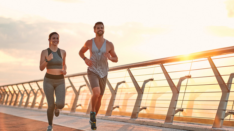 Couple running as the sun sets