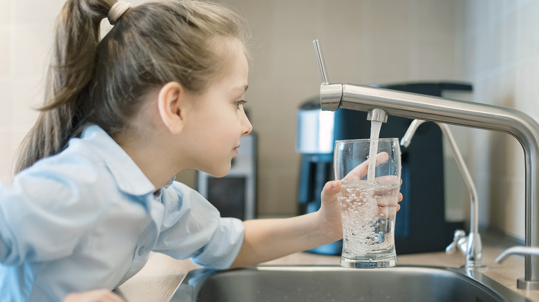 child using home water faucet