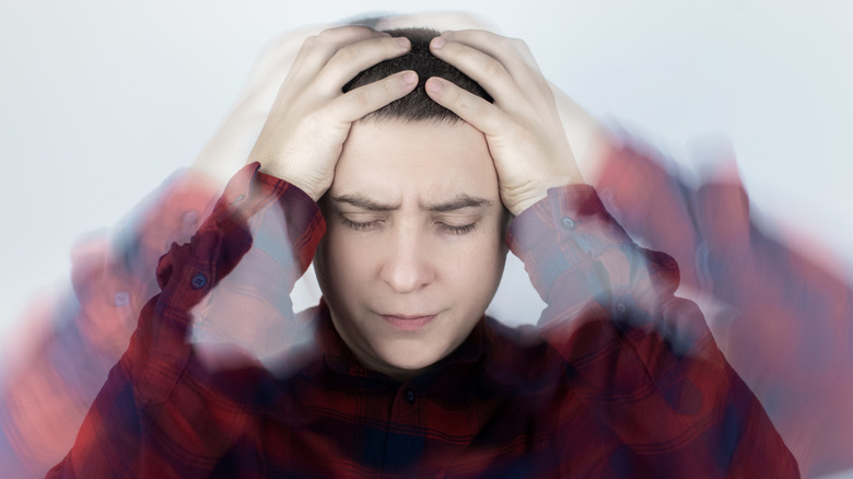 man holding his head